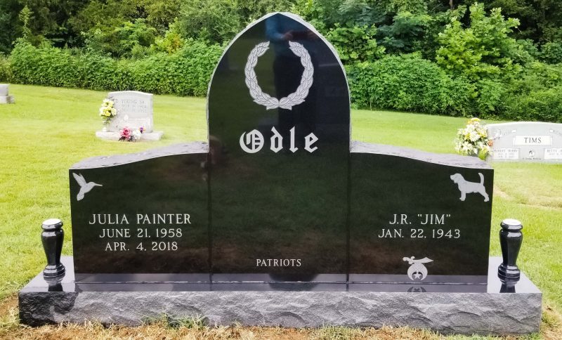 Odle Black Headstone with Hummingbird and Dog Carvings
